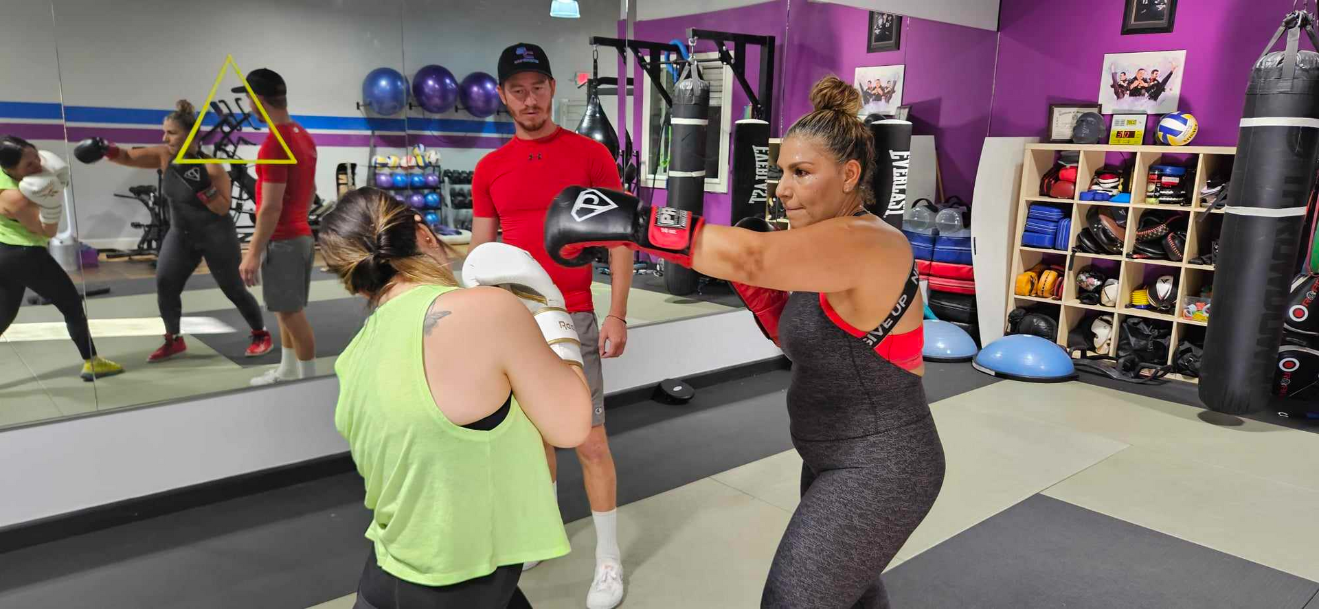A group of people are boxing in a gym.