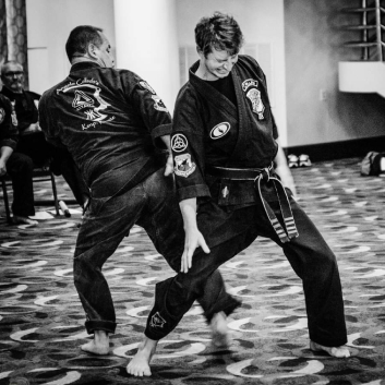 Two men are practicing martial arts in a black and white photo.