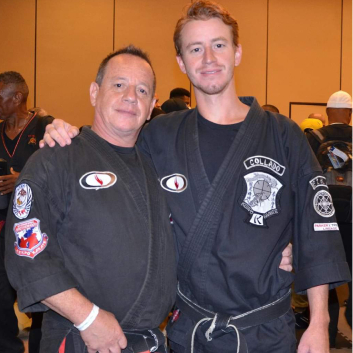 Two men are posing for a picture and one has a patch on his arm that says k.s. karate