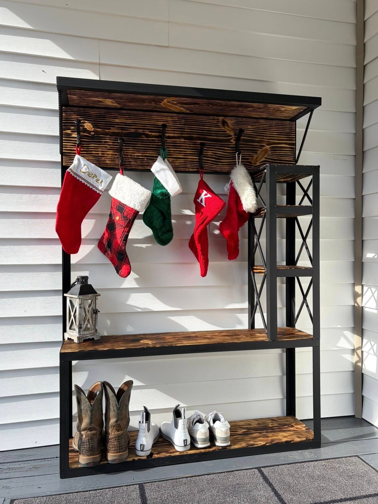 Christmas stocking display with metal frame, wooden shelves, and boots.