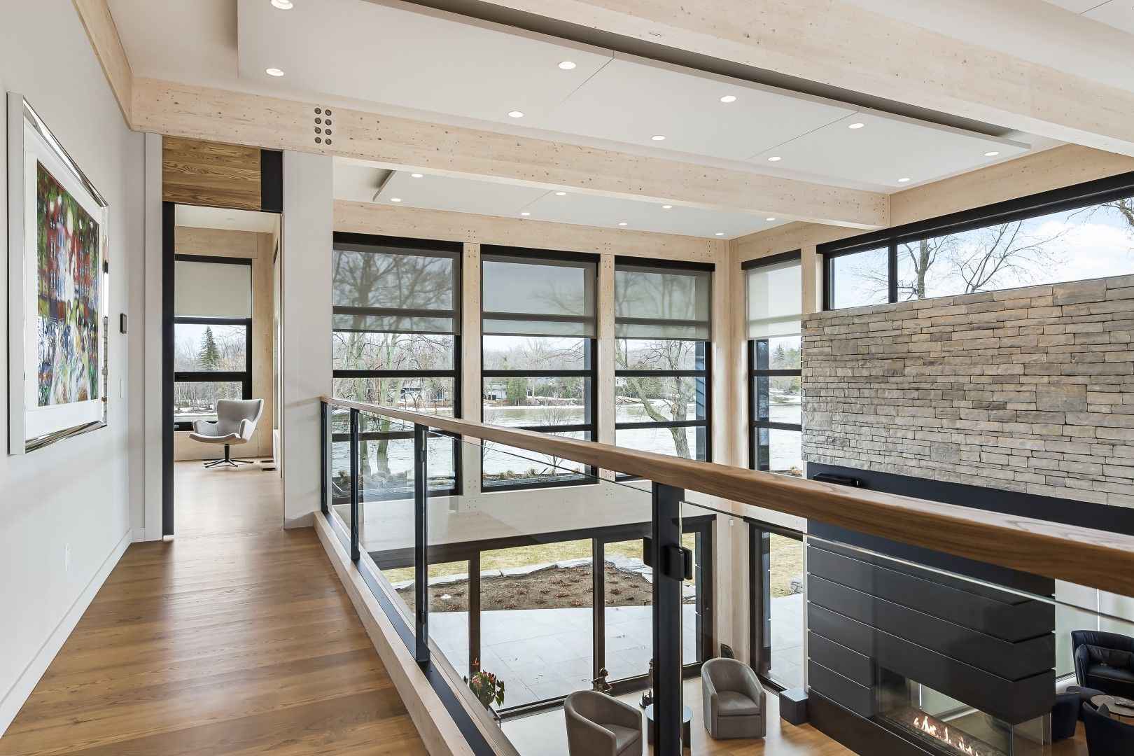Modern living room with motorized PowerShades and floor-to-ceiling windows