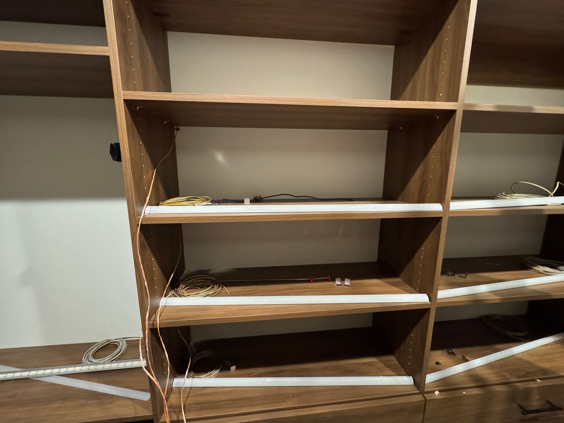 Installation process of LED lighting for custom master closet by Rivas Technology Group.