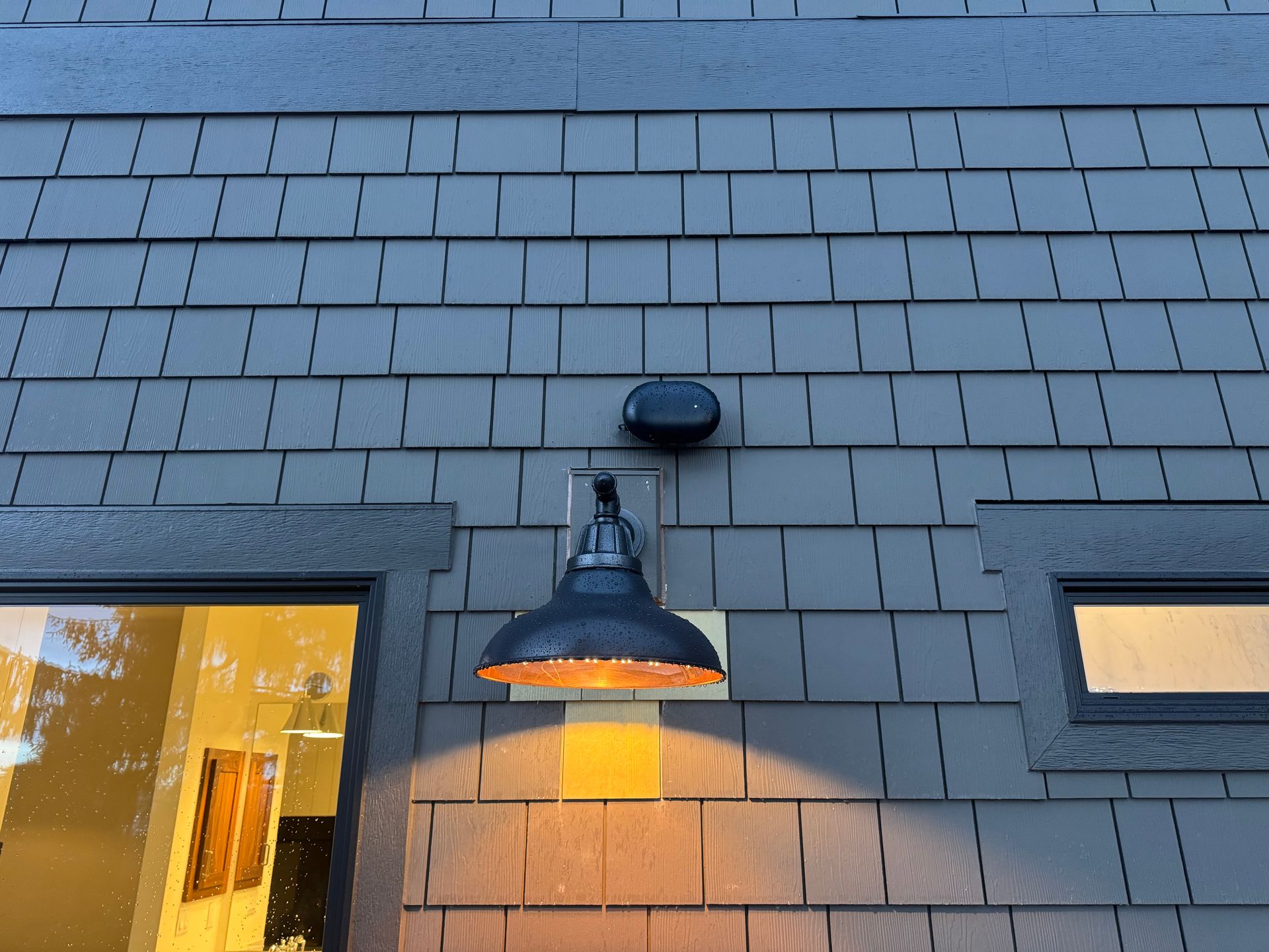 Weatherproof Wi-Fi access point installed above outdoor lighting fixture