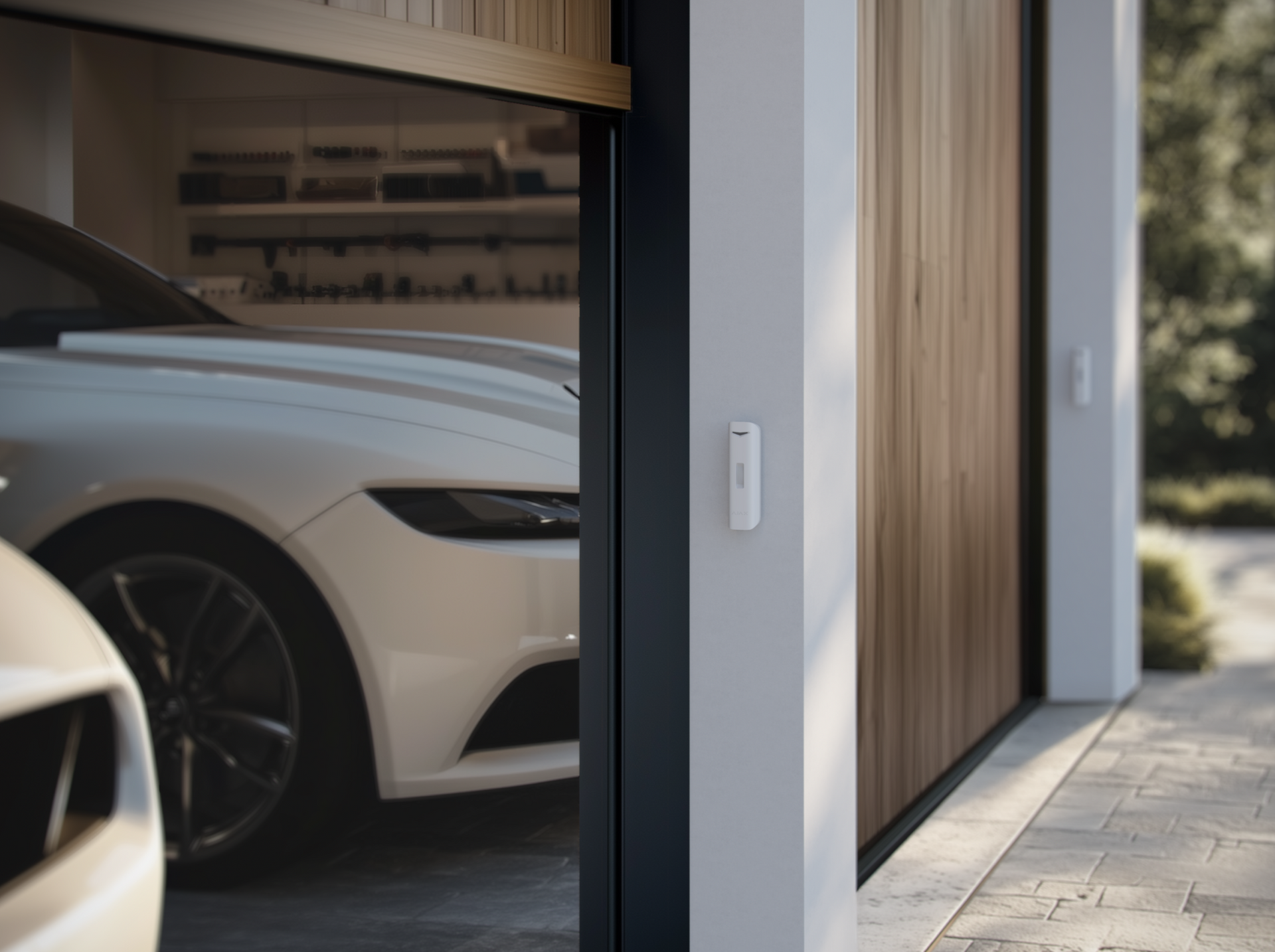 Ajax door sensor installed on modern garage for real-time entry alerts.