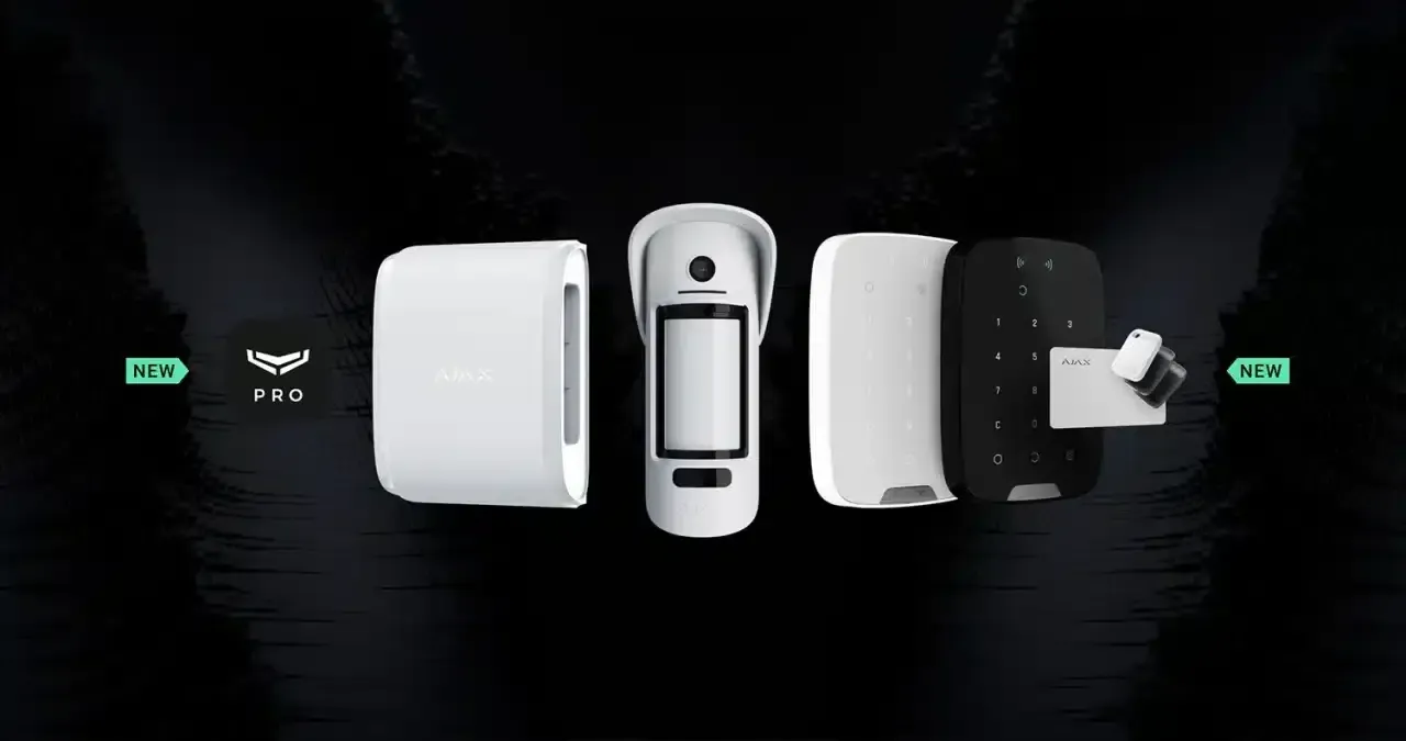 White and black security system components laid out against a dark background, with green power indicators.