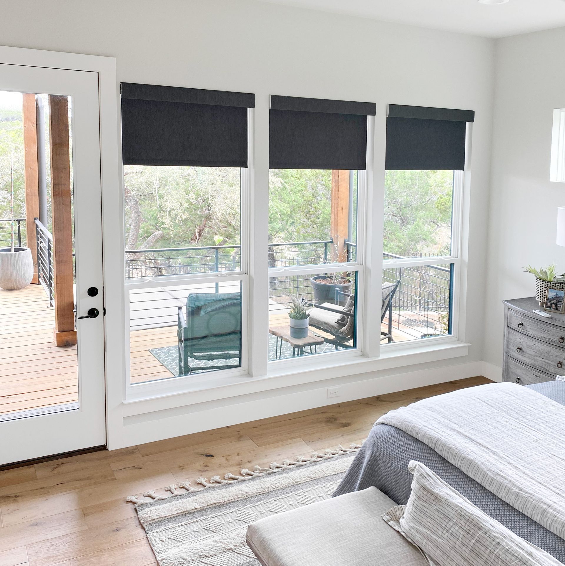Motorized bedroom shades with outdoor deck view in Puyallup home