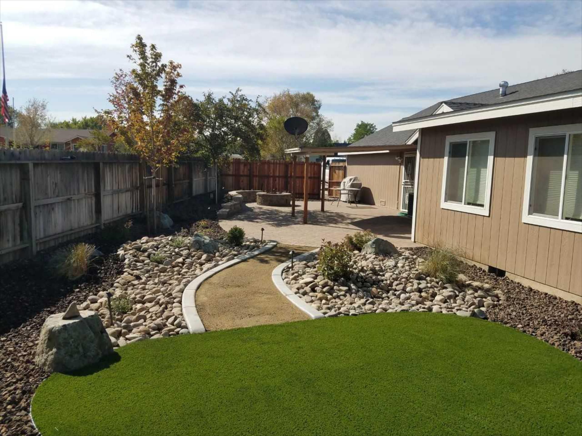A house with a lush green lawn in front of it.