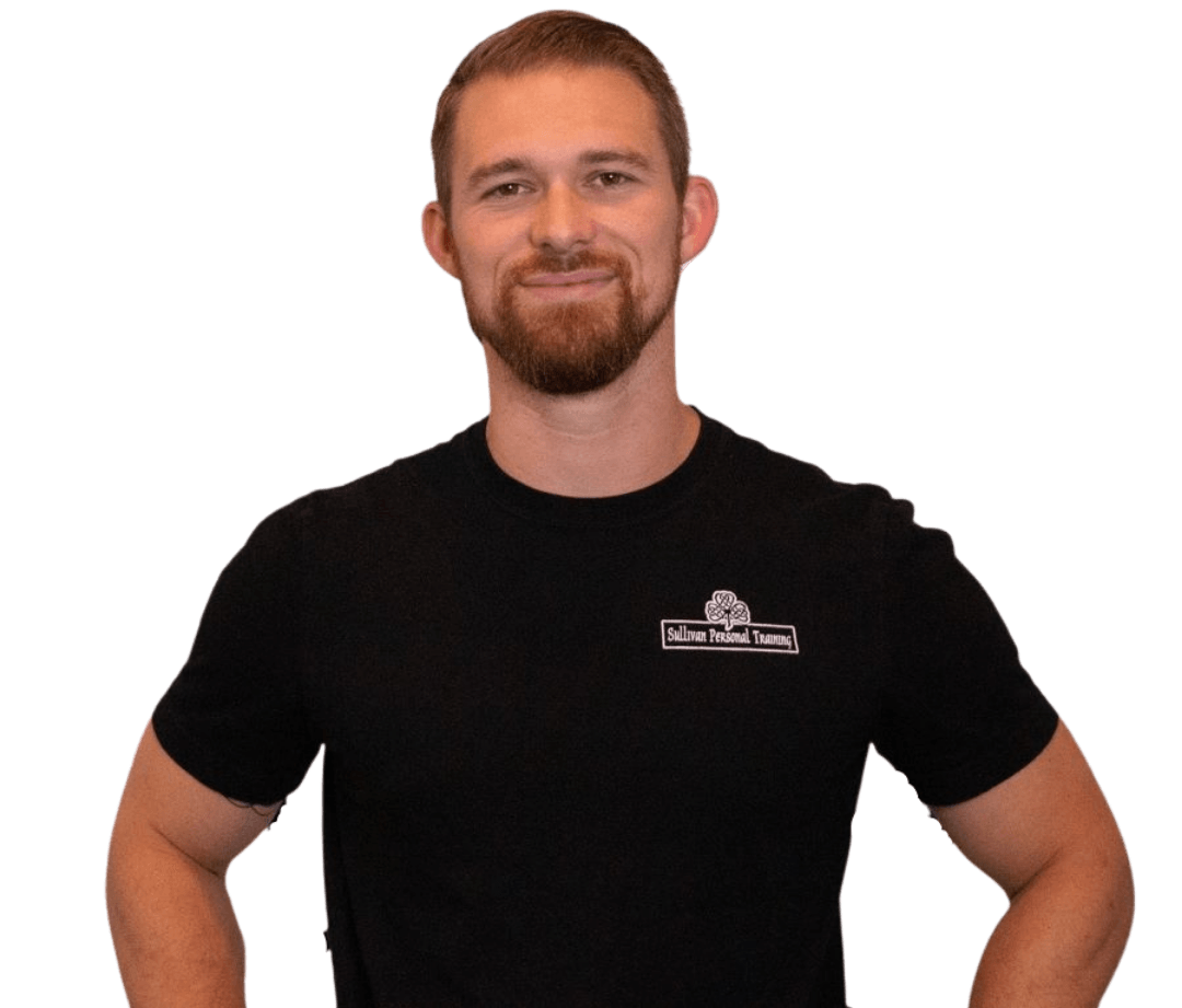 Man in a black T-shirt standing with hands on hips against a white background