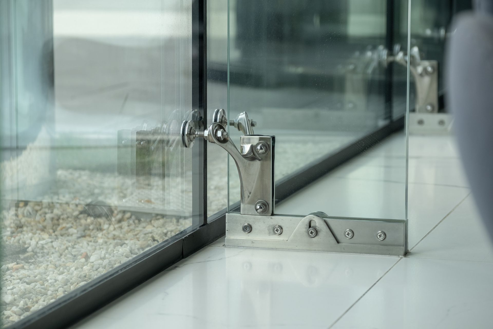 Stainless steel bracket securing glass panel for office glass installation Stainless steel bracket securing glass panel for office glass installation