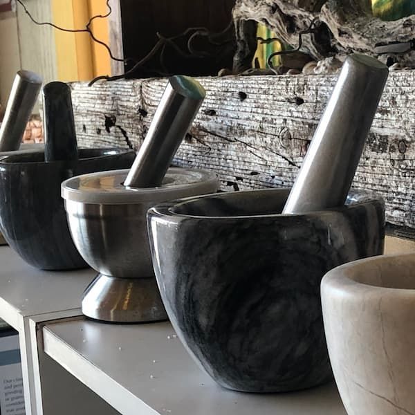 A row of mortars and pestles on a shelf