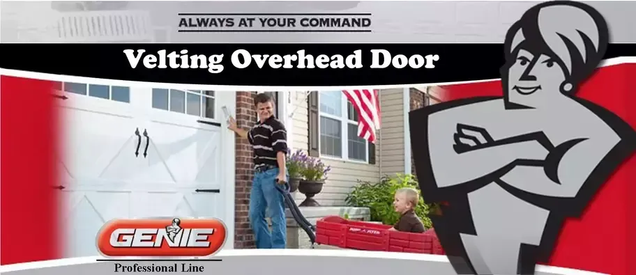 A man is standing in front of a garage door holding a vacuum cleaner.