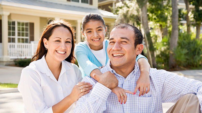 man and woman hugged by child