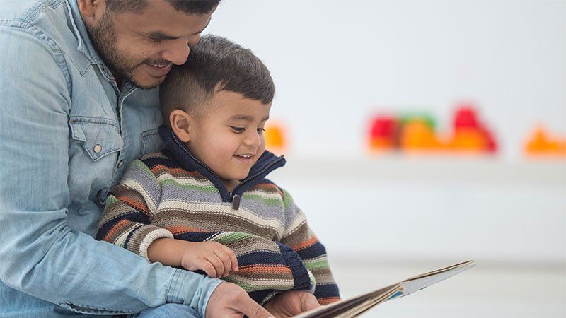 man reads to young boy