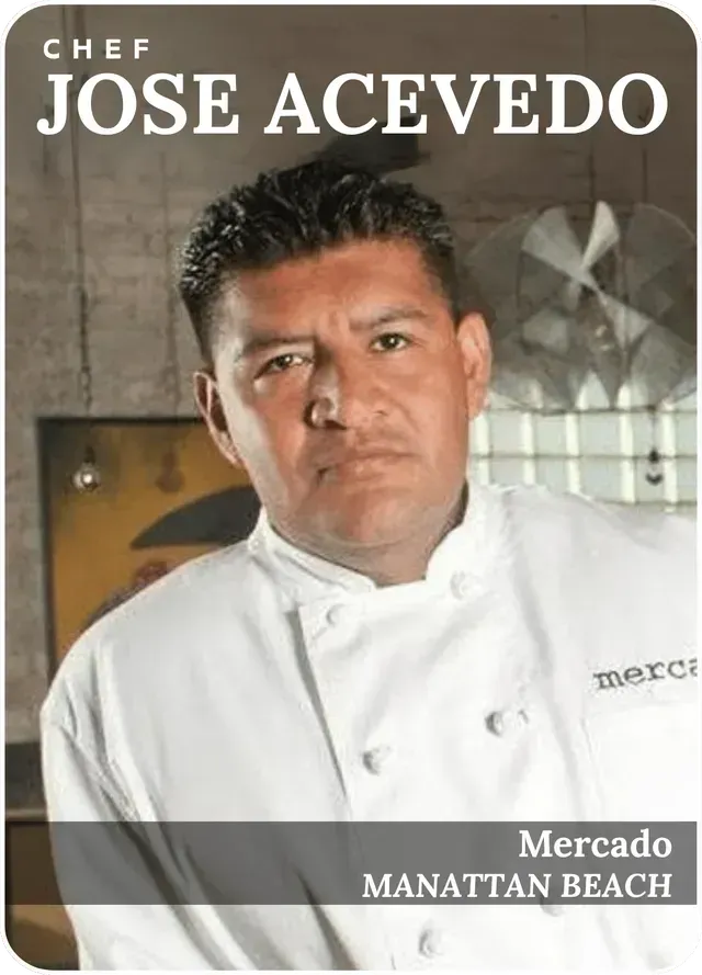 Chef José Acevedo in a white jacket, posing with a serious expression against a restaurant backdrop.