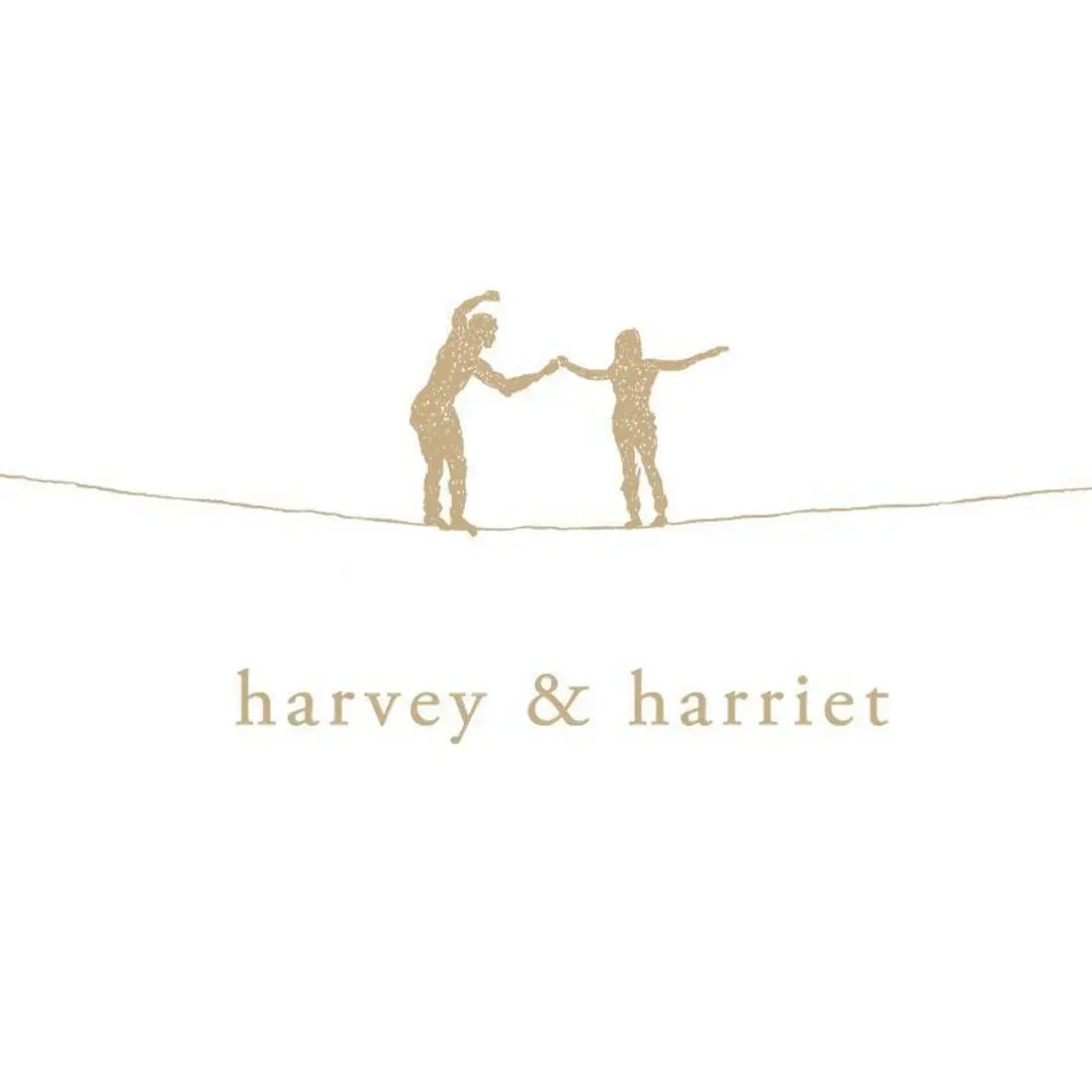 Gold logo of two figures holding hands above the text “harvey & harriet”