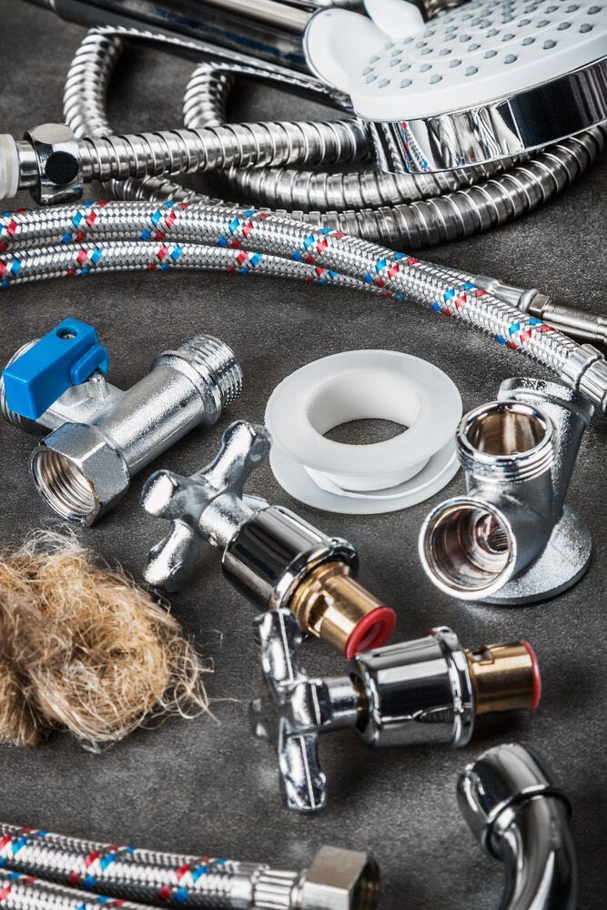 There Are Many Different Types of Plumbing Parts on the Table — MacKenzie Plumbing In Sarina, QLD
