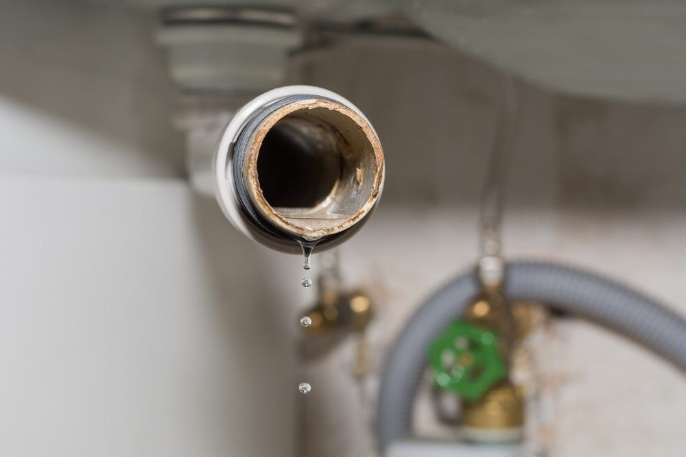 A Close Up of a Leaking Pipe in a Bathroom — MacKenzie Plumbing In Sarina, QLD