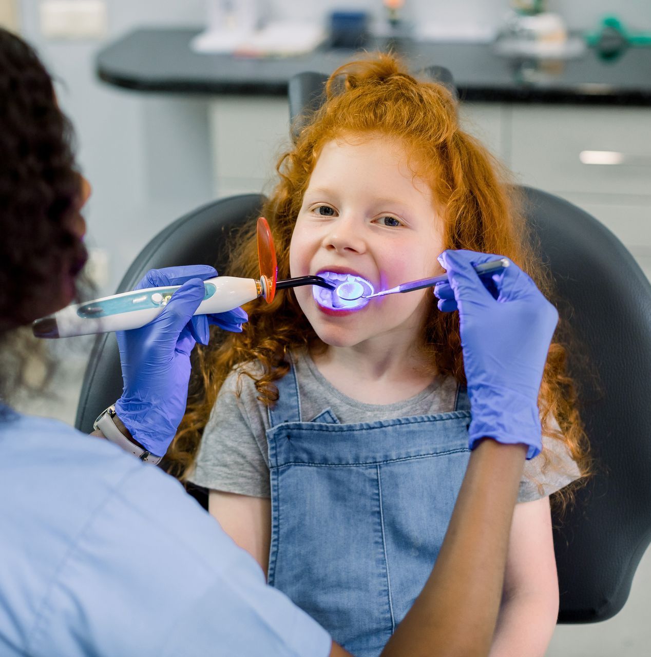 Durable fillings in East Norriton, PA for cavity repair. A little girl is getting her teeth examined by a dentist