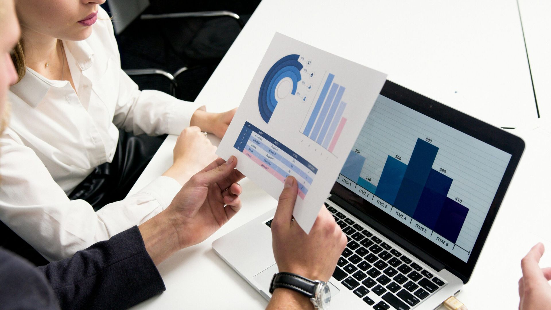 Two People Reviewing Charts and Graphs at a Desk, Using a Laptop — Accountsloop Tax & Business Advisory in Geelong, VIC