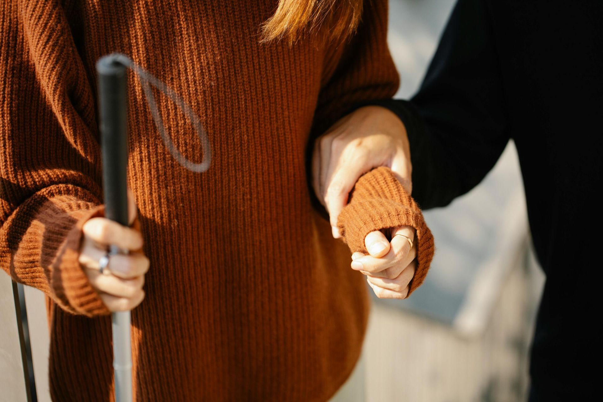 Person With Cane is Helped by Another, Both in Warm Sweaters — Accountsloop Tax & Business Advisory in Geelong, VIC