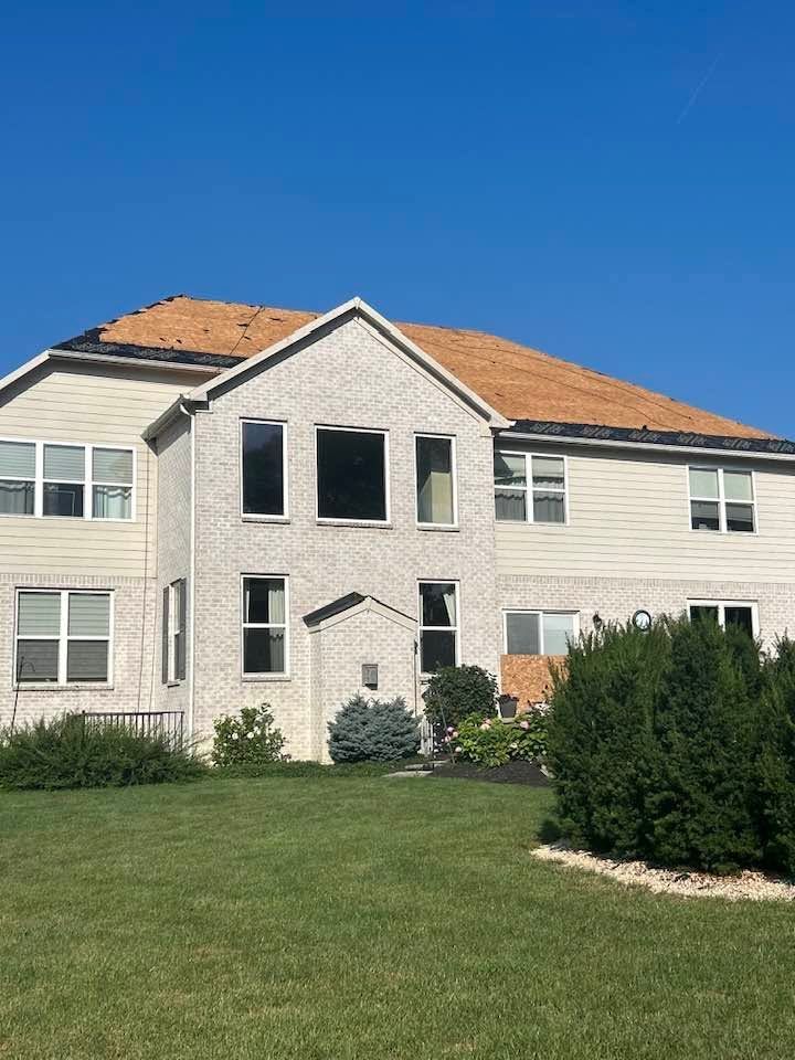 Two-story beige house undergoing construction