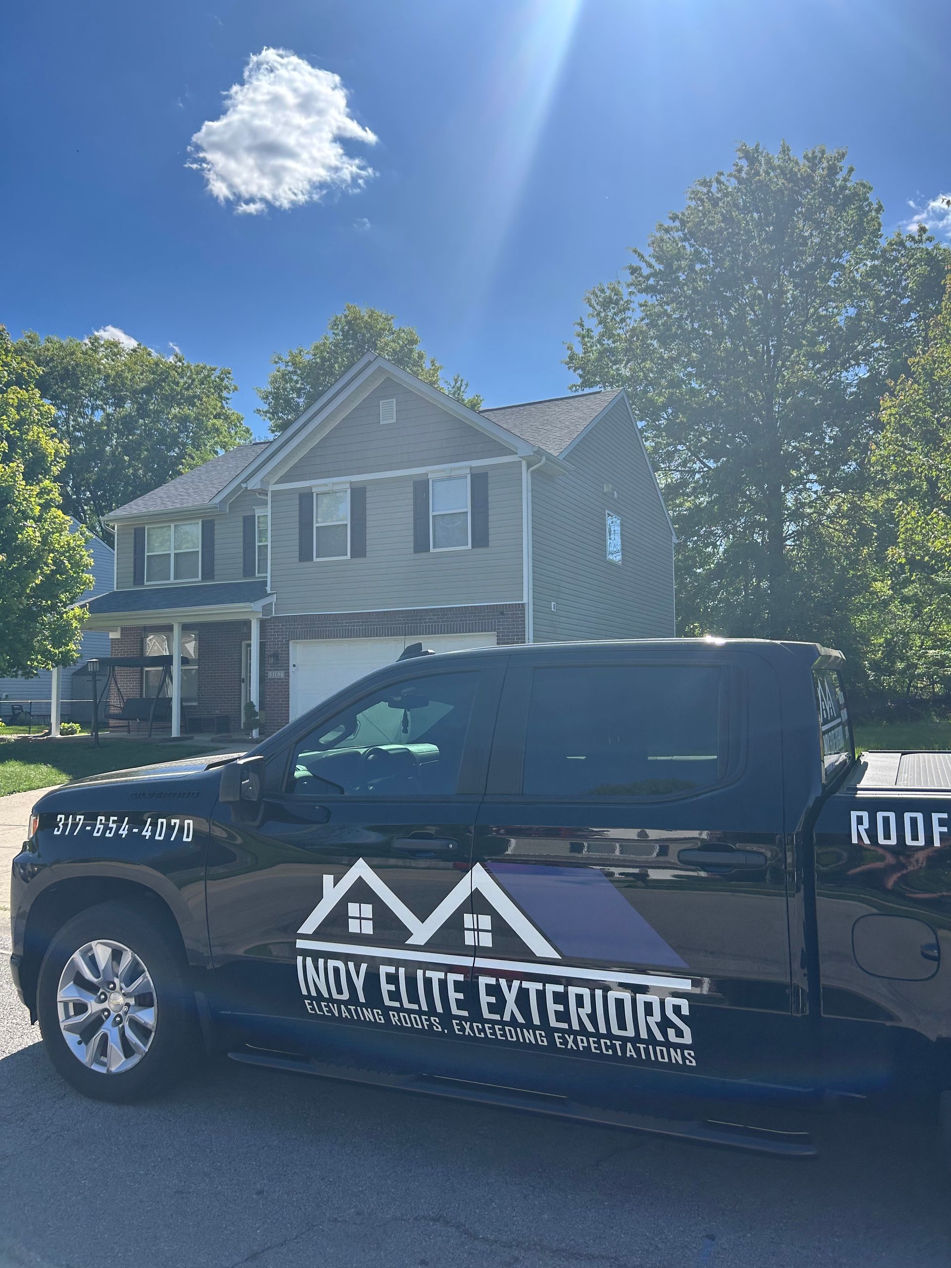 Black roof replacement vehicle that reads 