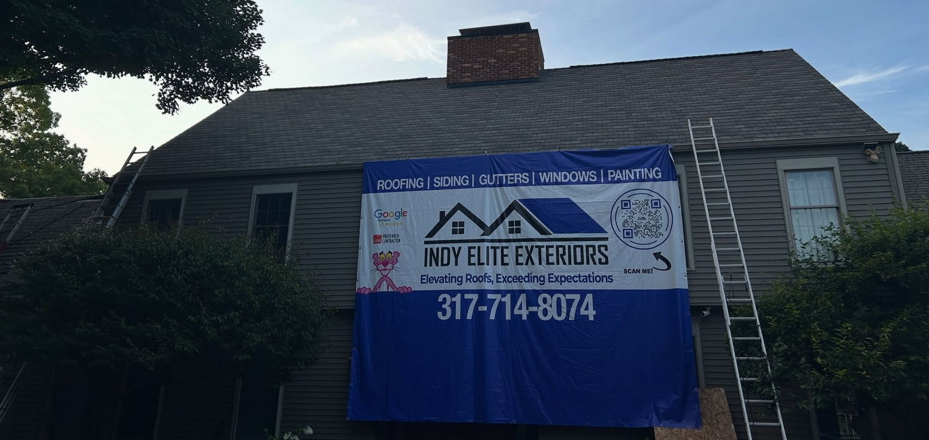 After image of a replaced gray asphalt shingle roof on a home with a ladder leaning up against the side of the house