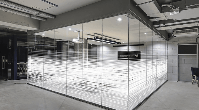 A large empty room with a lot of glass walls.