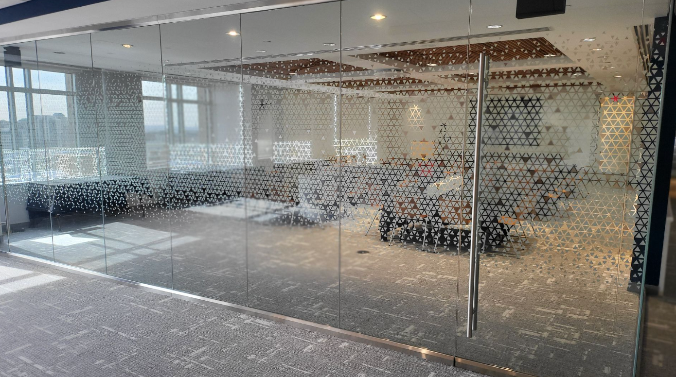 A large room with a lot of windows and a glass wall.