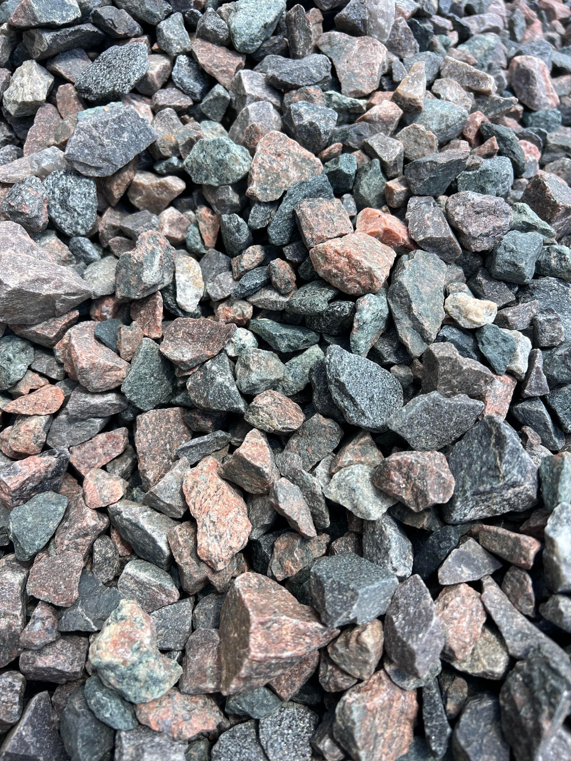A pile of rocks is sitting on the ground.