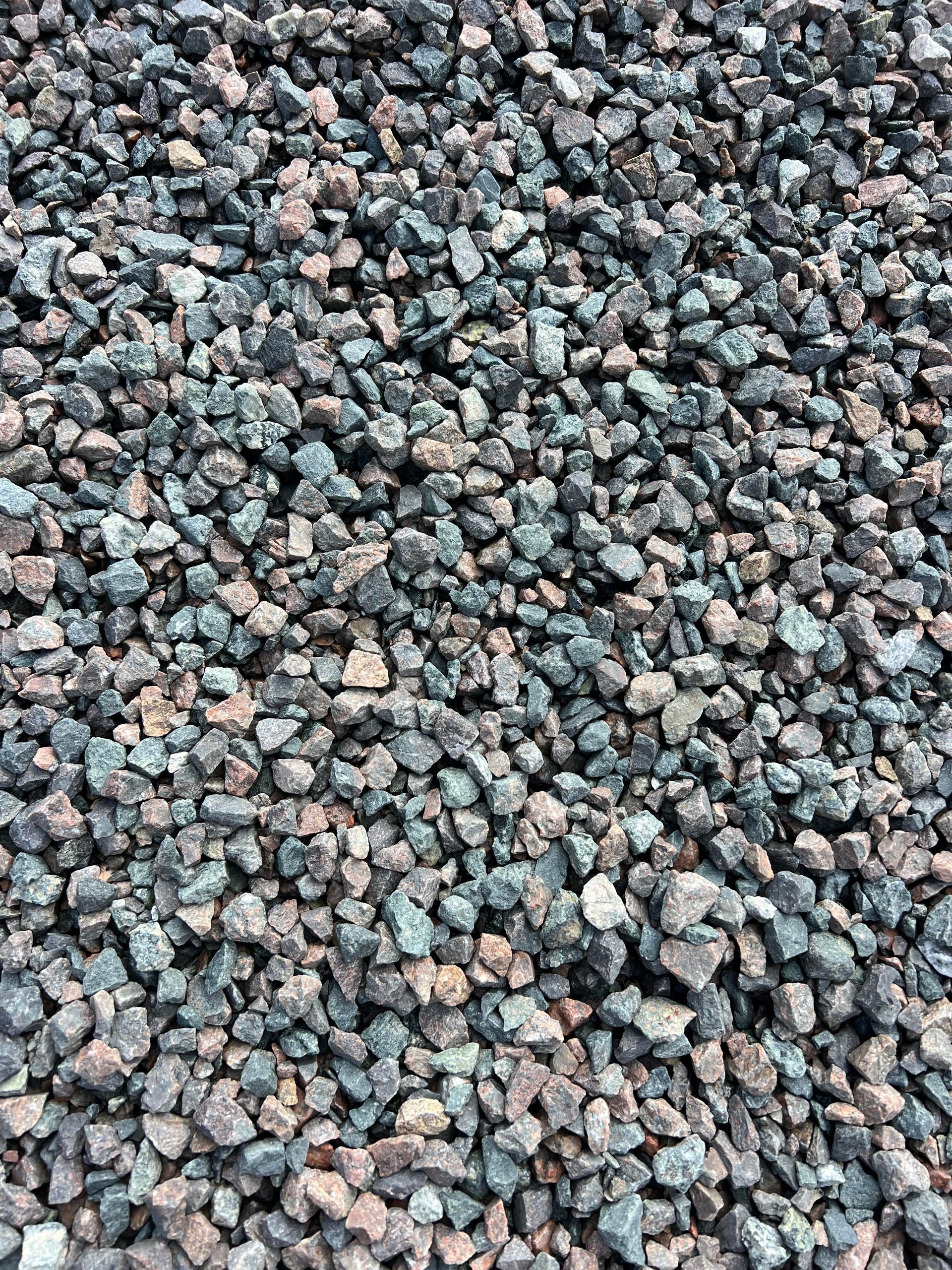 A pile of gravel is sitting on the ground.