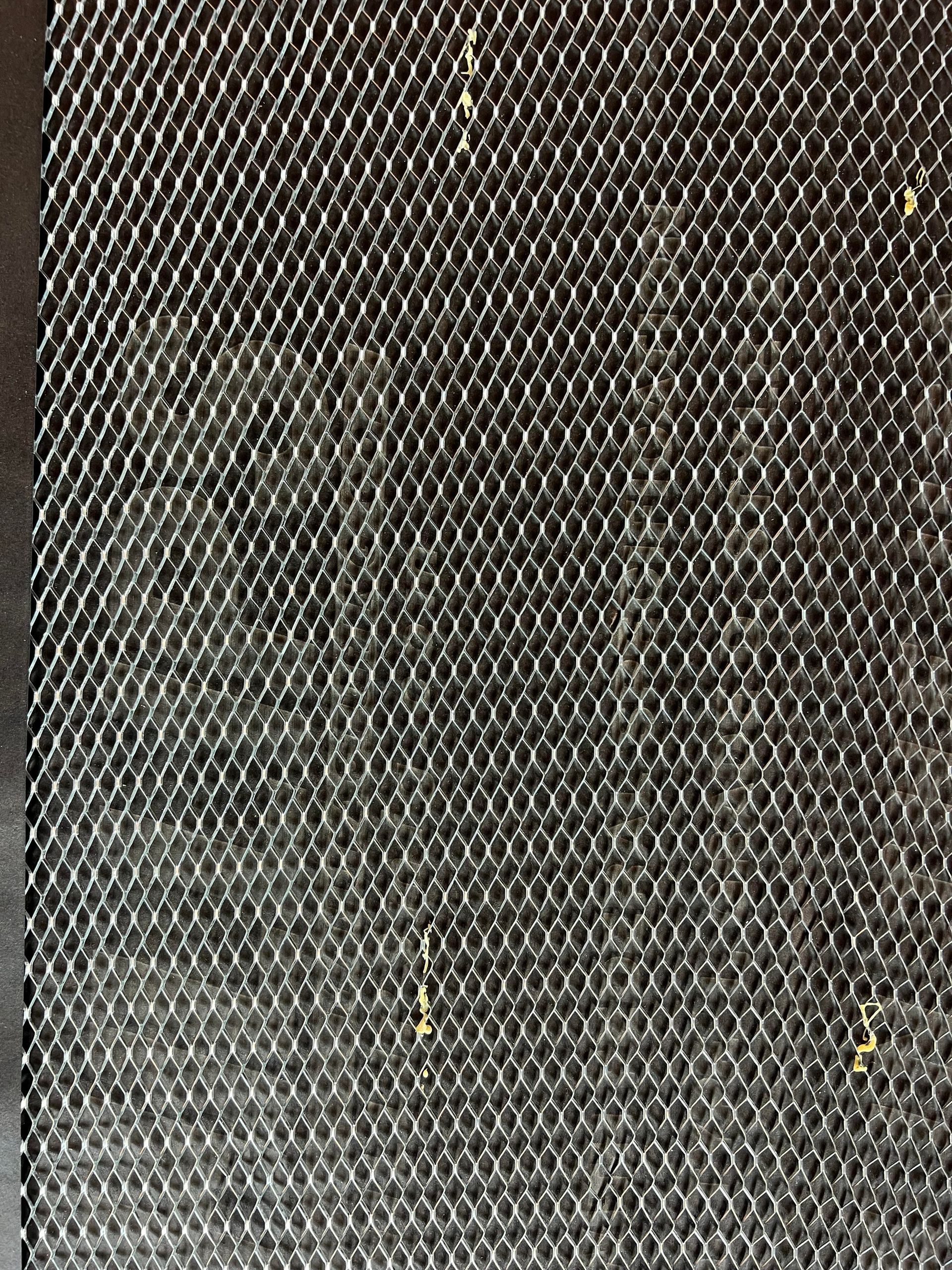 A close up of a black mesh fabric with holes in it.