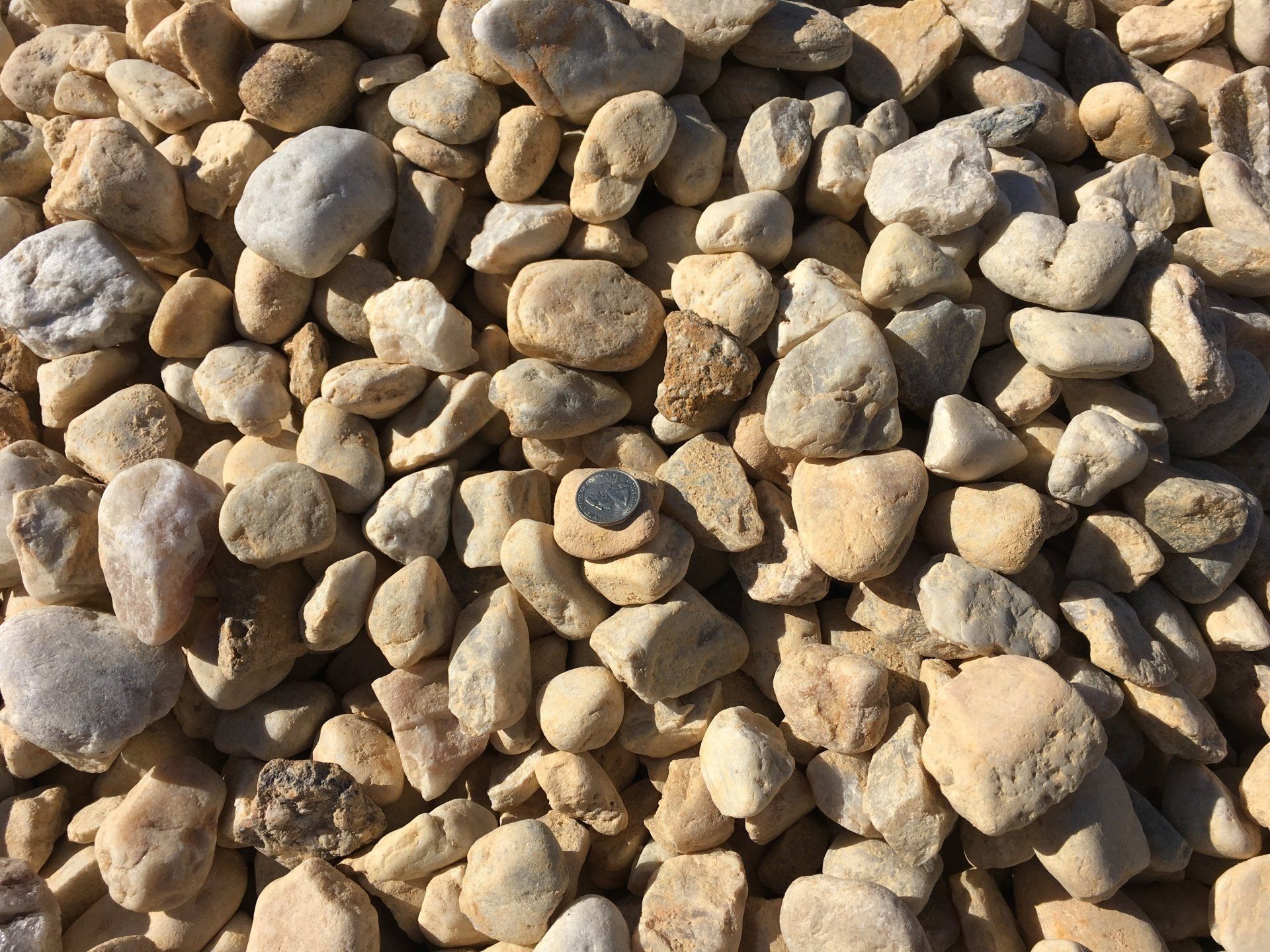 A pile of rocks with a coin in the middle.
