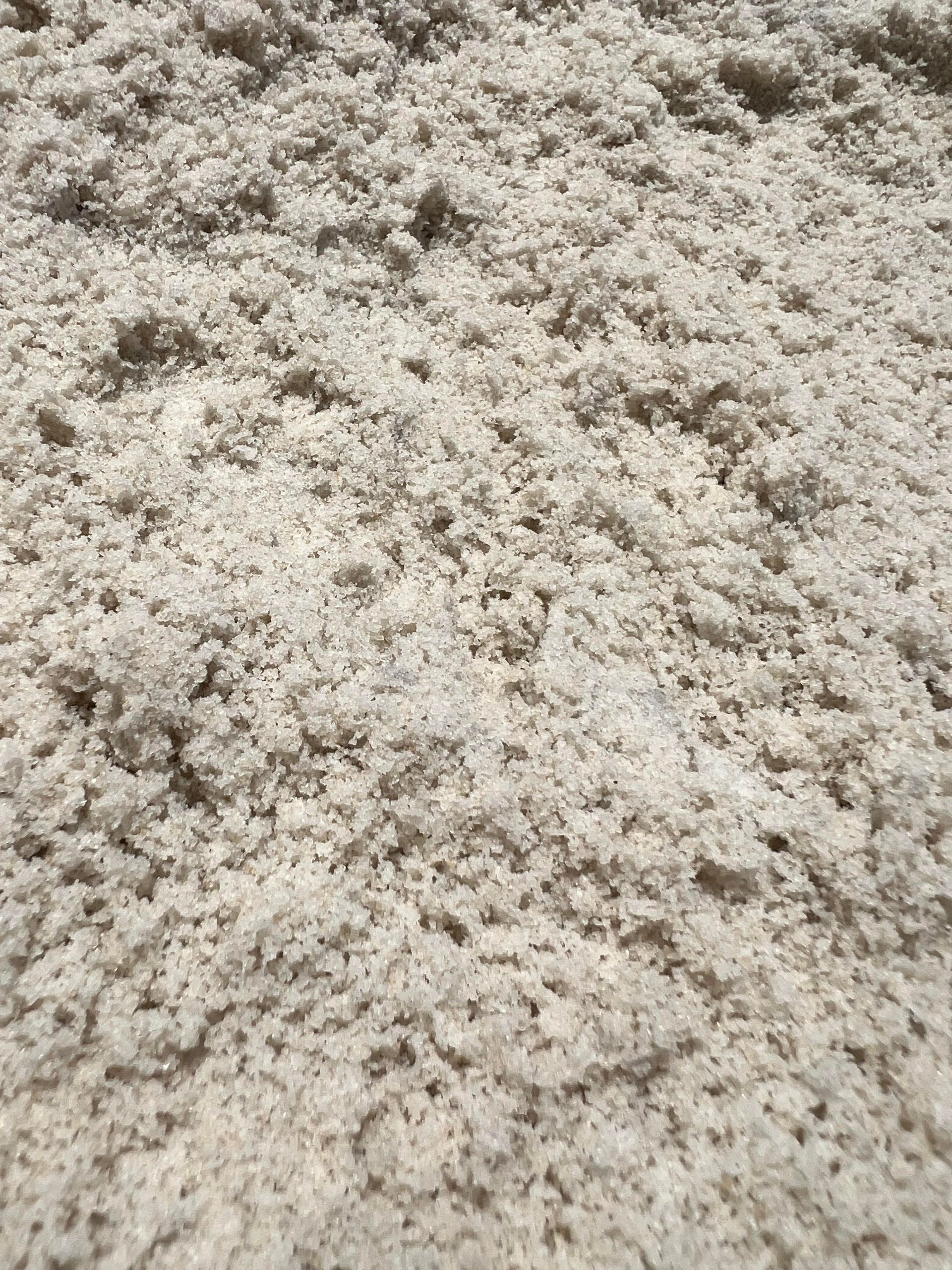 A close up of a pile of white sand.