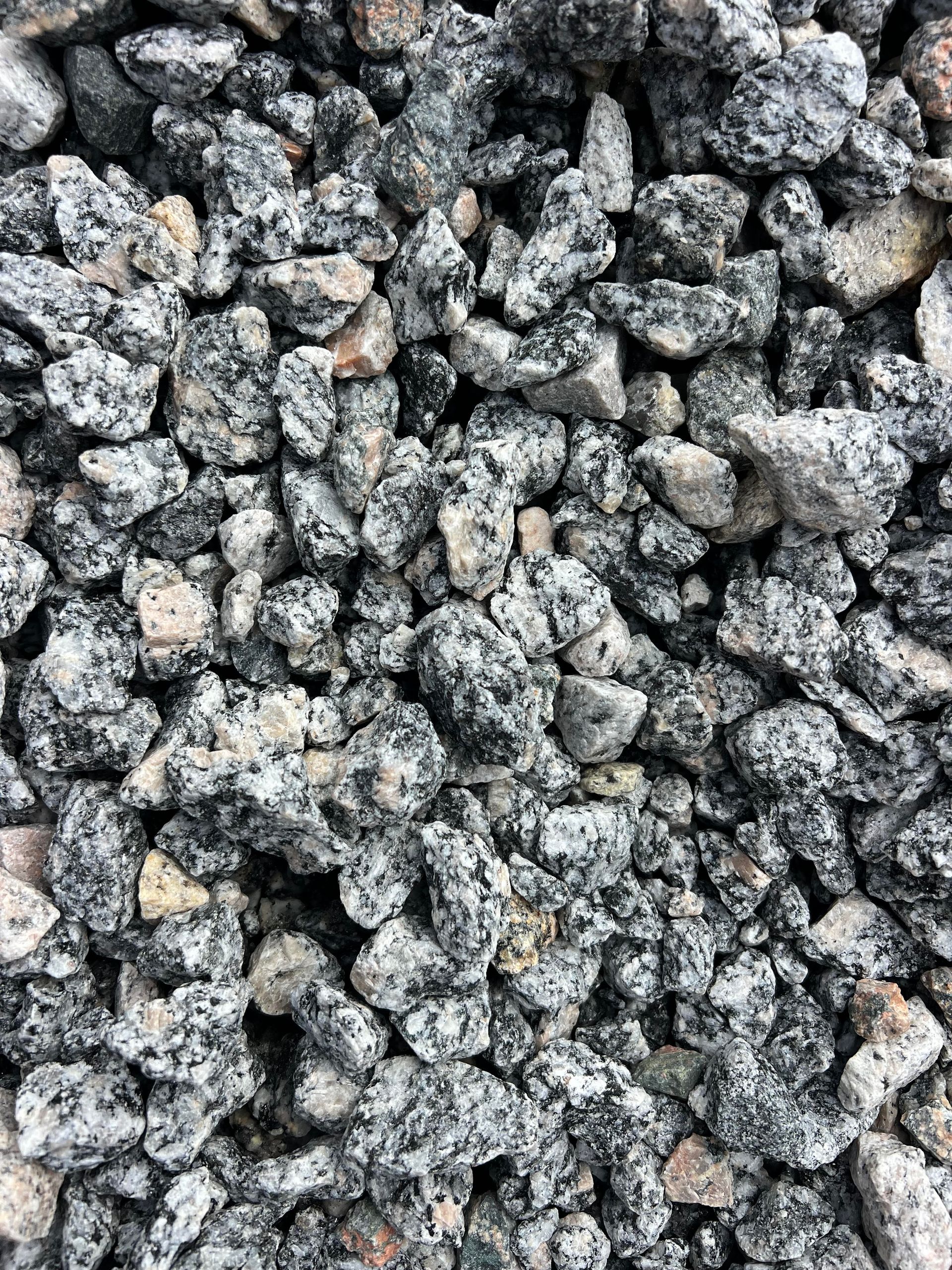 A pile of gravel is sitting on the ground.
