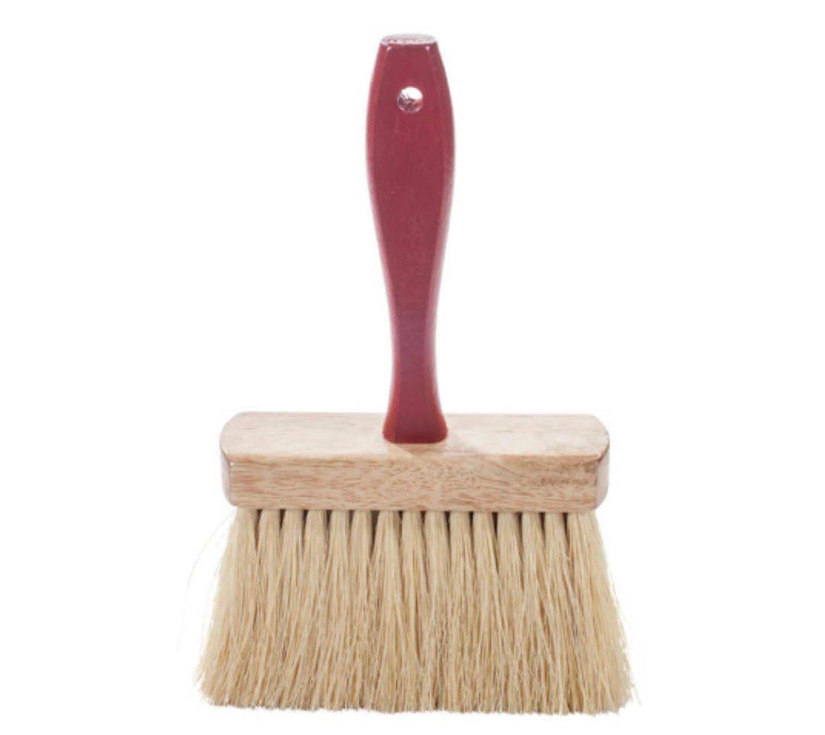 A small brush with a red handle on a white background