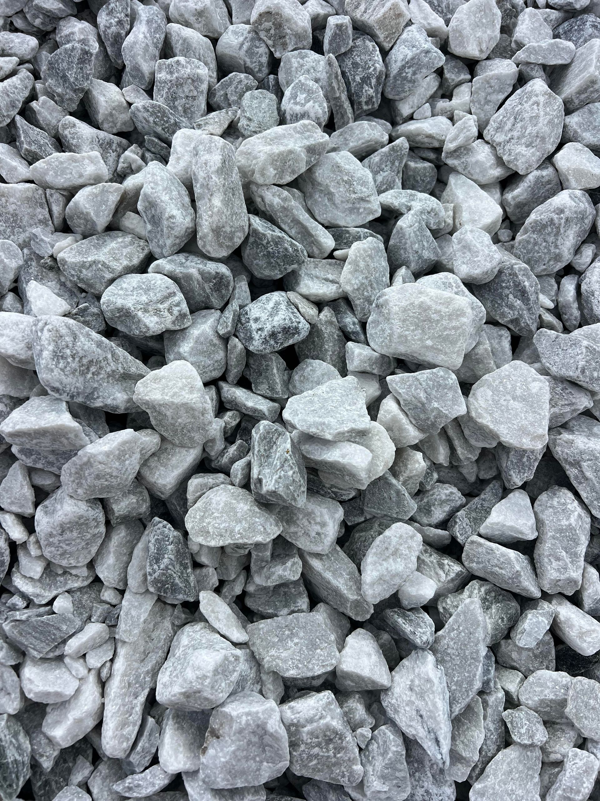 A pile of gray gravel is sitting on the ground.