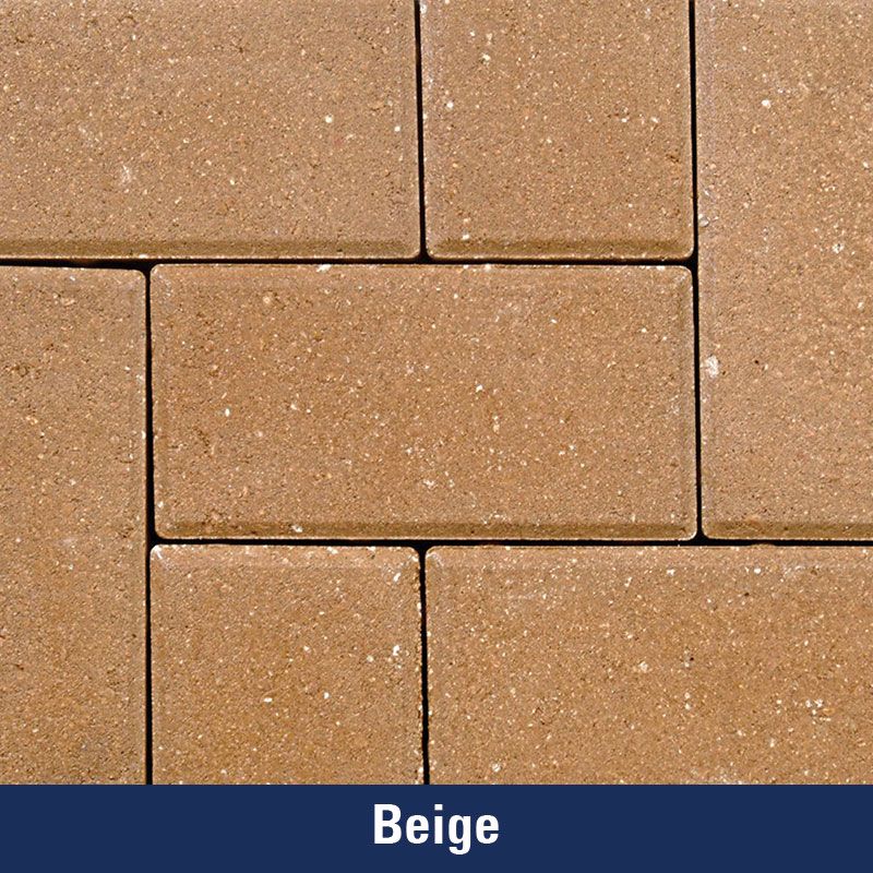 A close up of a beige colored brick wall
