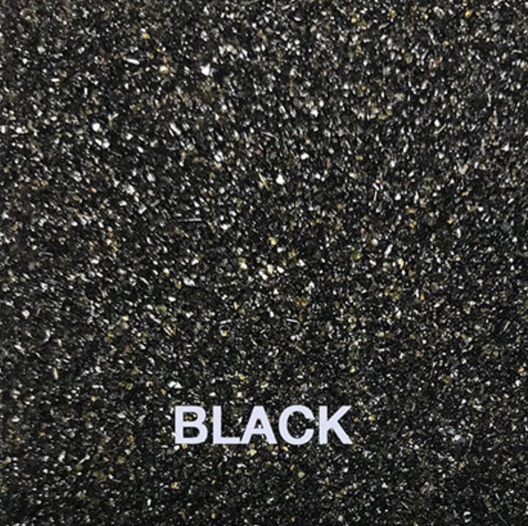 A close up of black glitter with the word black on it