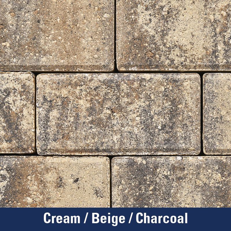 A close up of a brick wall in cream beige and charcoal