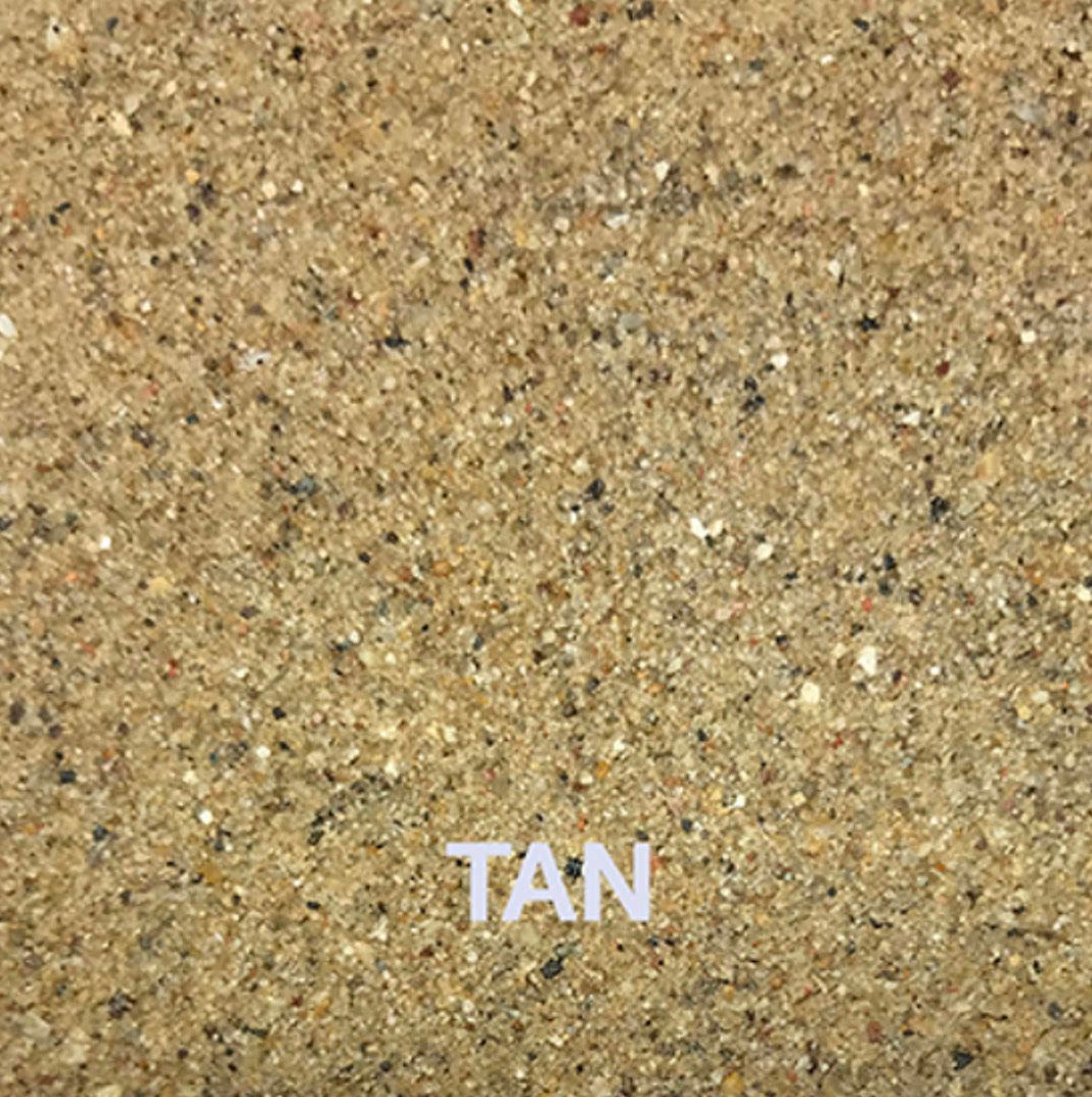 A close up of a tan sandy surface with the word tan written on it.
