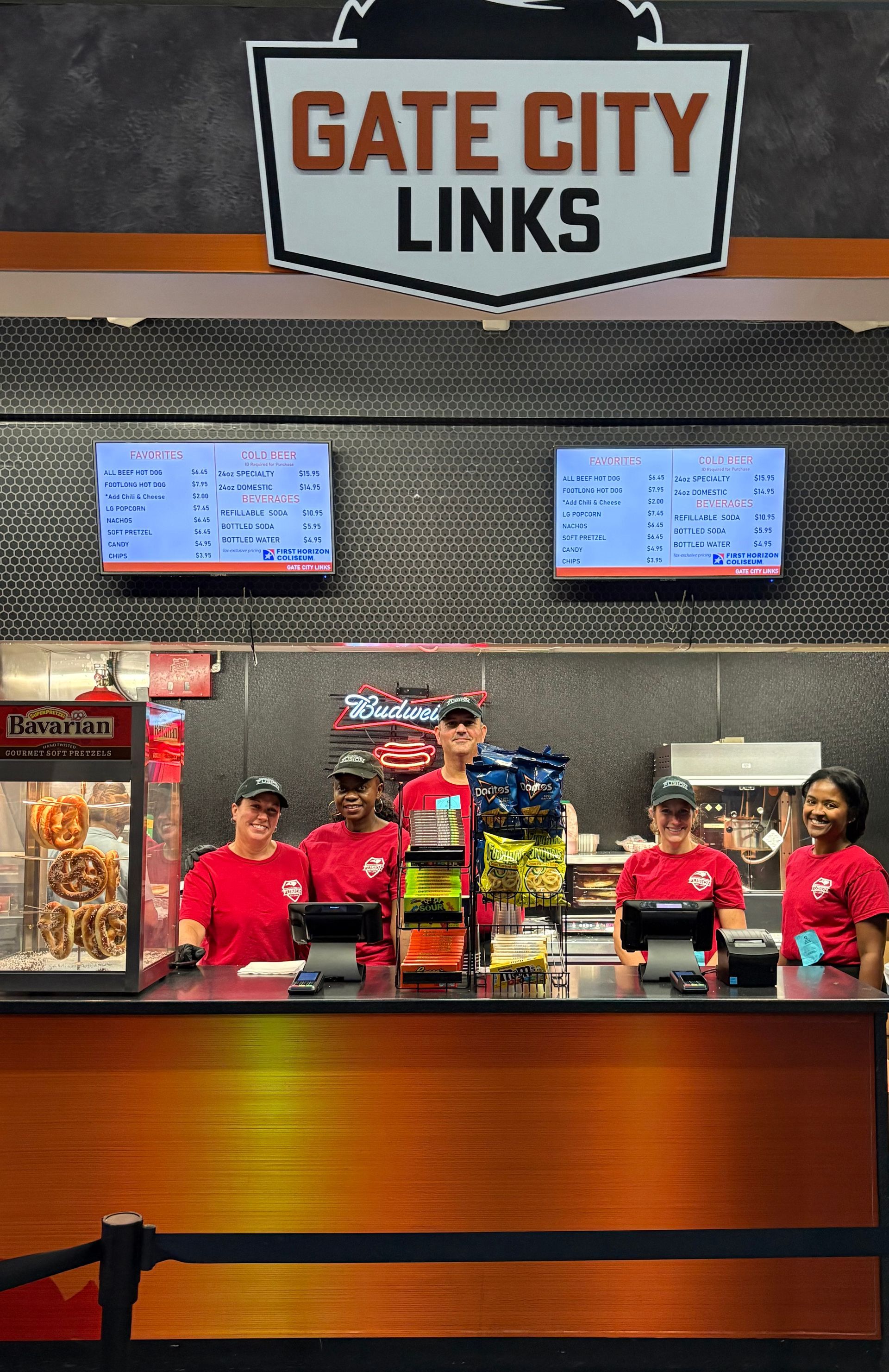 Gate City Links concession counter with staff in red shirts and menu screens above the counter