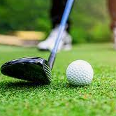 Golf club and ball on a green tee box, ready for a shot.