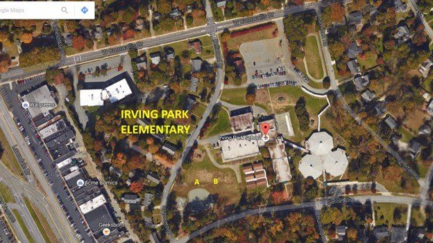Aerial view of Irving Park Elementary school campus with surrounding trees, roads, and nearby buildings