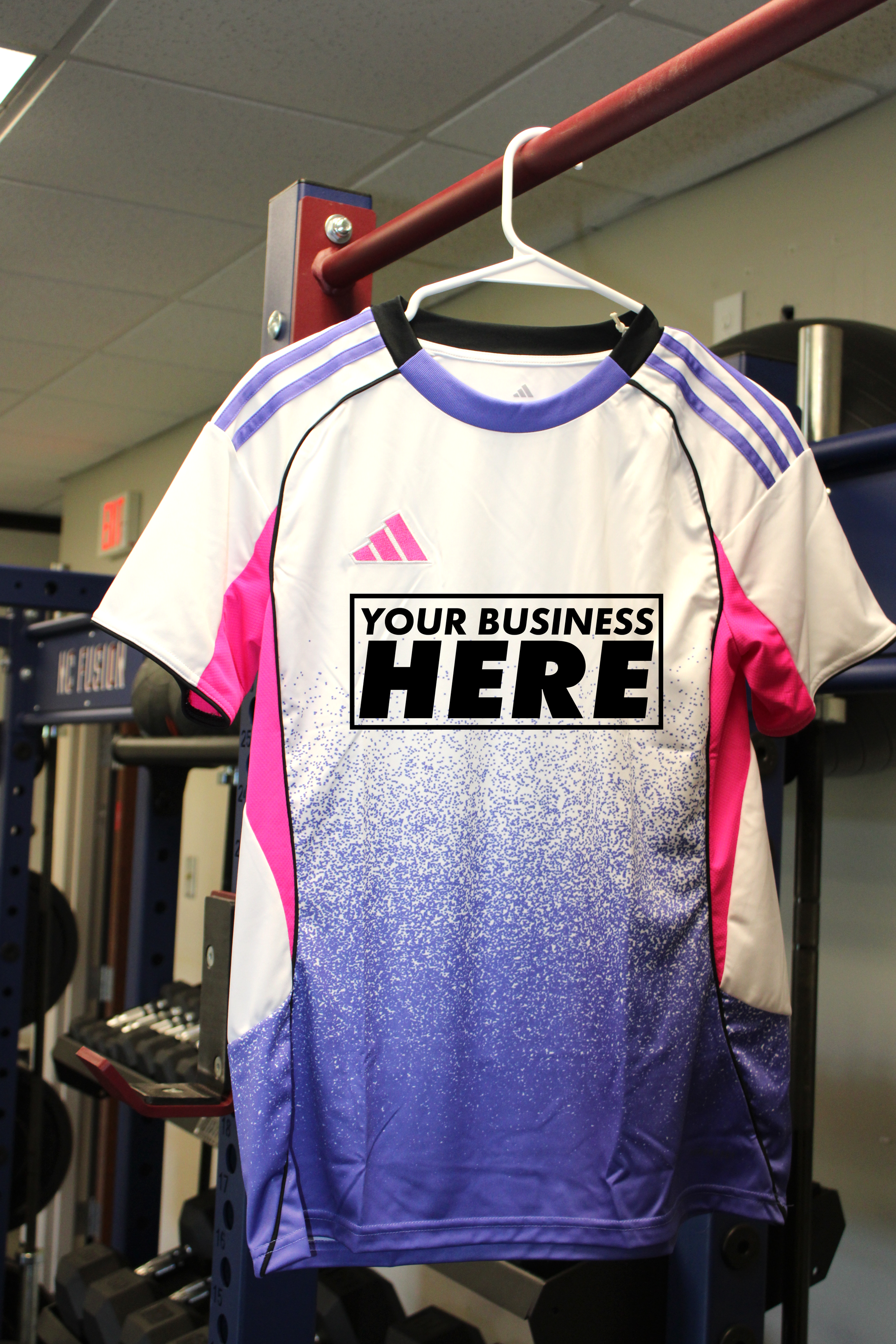 White, pink, and blue sports jersey on a hanger with “YOUR BUSINESS HERE” on the chest