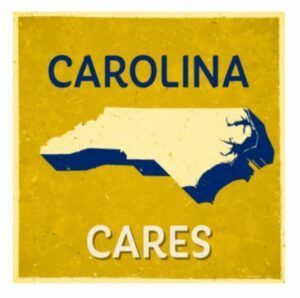 Yellow Carolina Cares sign with North Carolina silhouette in blue and white