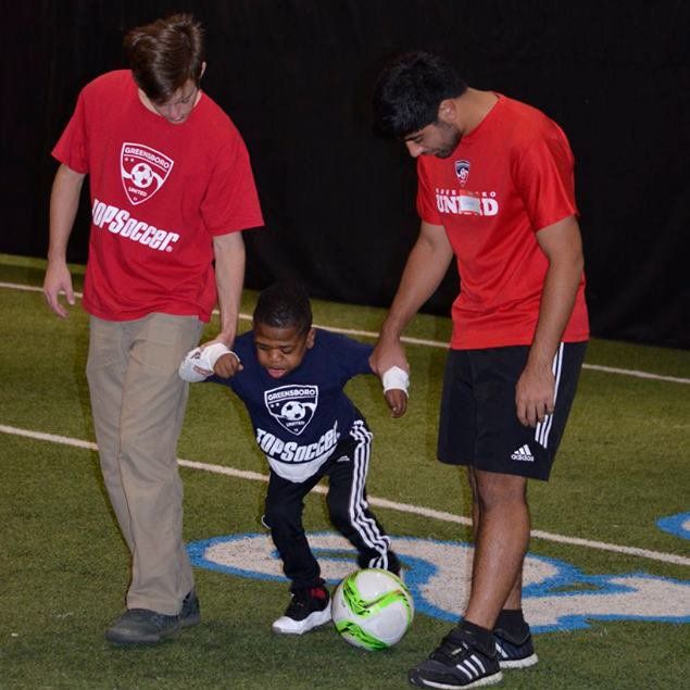 Photo of two buddy volunteers assisting a participant.