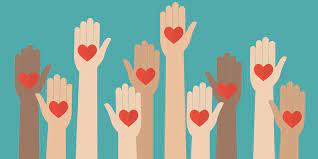 Raised hands holding red hearts against a teal background