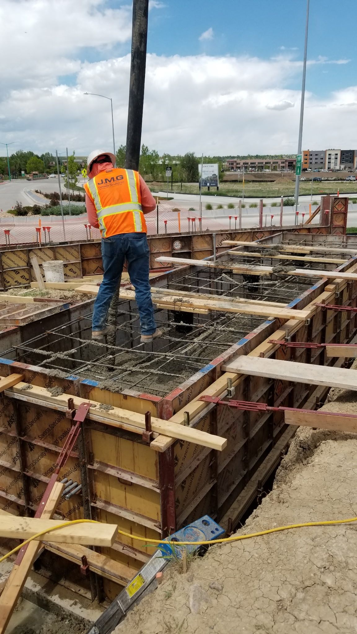 A group of construction workers are working on a road.