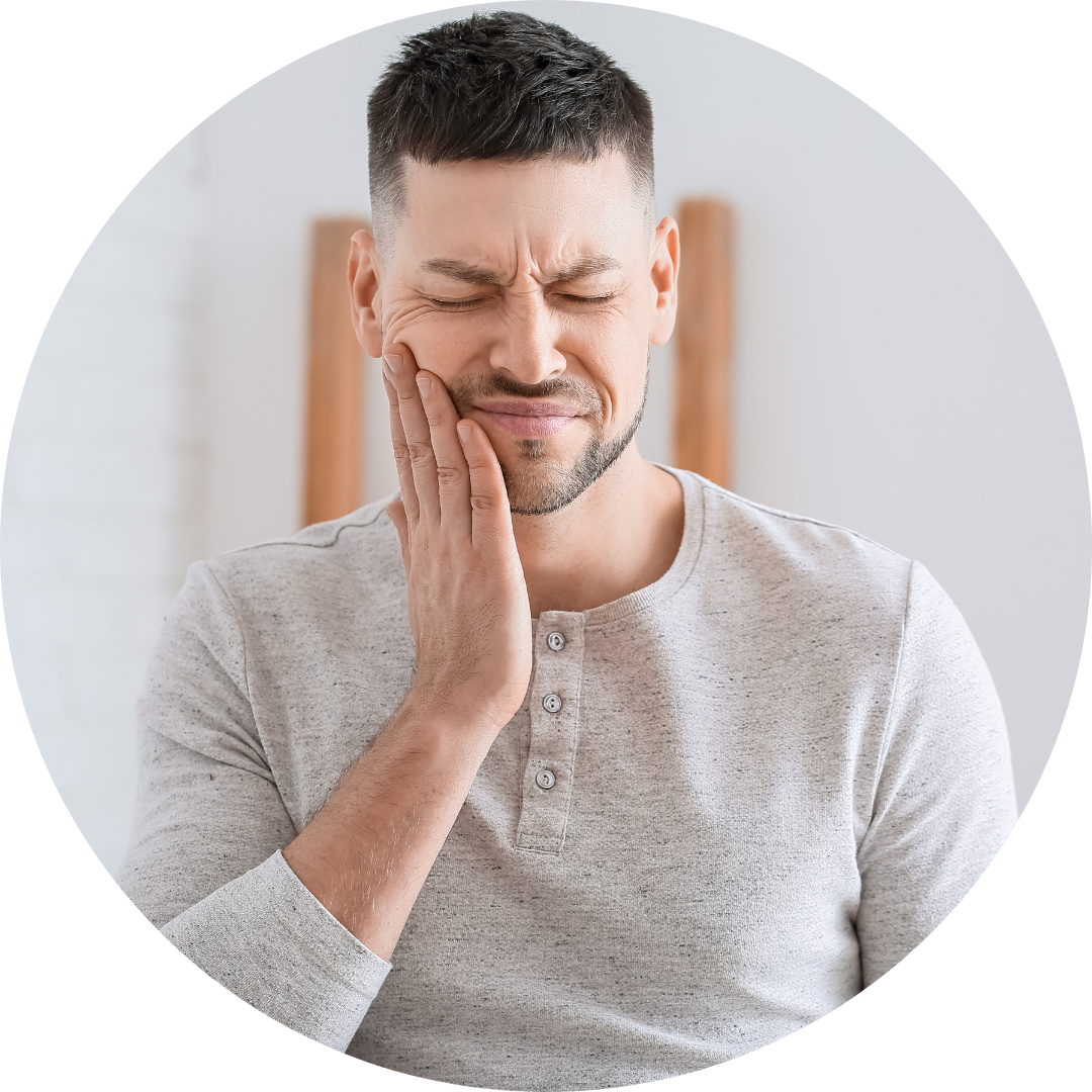 Man holding his cheek with eyes closed, showing discomfort against a light background